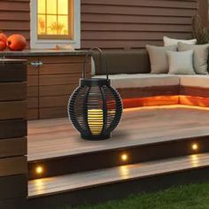 an outdoor deck with lights on it