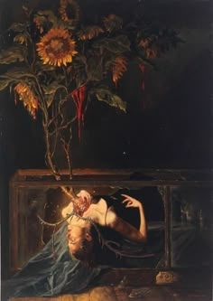 a painting of a man laying on the ground next to a sunflower tree in a box