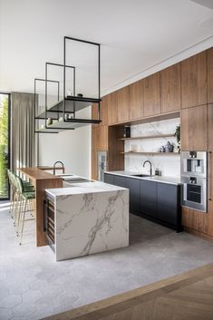 an open kitchen and dining area with marble counter tops