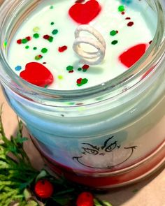 a glass jar filled with liquid and sprinkles on top of a table