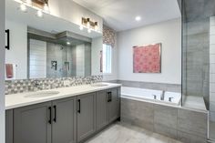 a large bathroom with two sinks and a bathtub