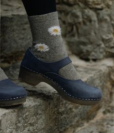 Mary Jane – the perfect blend of style and comfort. Handmade in Sweden, these low-heeled closed-back clogs are a must-have for any conscious customer looking to add sophistication to their wardrobe. With an undeniable cute factor, you'll feel confident and on-trend with every step. Clog measurements:Heel height: 1 3/4” (4.45 cm)Toe height: 1 5/8″ (4.1 cm)Fit:RegularLeather:Nubuck leatherClogs consist of:Base: European lime woodSole: Rubber soleFastening: StaplesOther: Metallic Buckle Casual Non-slip Comfortable Clogs, Non-slip Closed Toe Clogs, Affordable Non-slip Clogs For Women, Non-slip Synthetic Closed Toe Clogs, Playful Non-slip Synthetic Clogs, Modest Mom, Womens Wide Shoes, Mary Jane Clogs, Cork Sandals