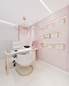 an office with pink walls and pictures on the wall, along with a white chair