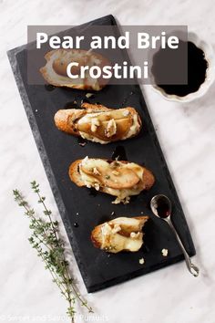 pear and brie crostini on a black slate platter