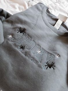 Spooky Season + Spiders Custom Embroidered Crewneck Sweater / Jumper MADE TO ORDER How to Order: 1. Pick your crewneck color and size. 2. Customize your design with up to 3 thread colors.       Color 1: Spooky Season       Color 2: Big Spiders       Color 3: Little Spiders Kid Sizes? Totally! Just drop me a message, and we'll sort it out :) Grab yours now and enjoy Spooky Season in style! Spider Sweater, Big Spiders, Thread Colors, Embroidered Crewneck, Sweater Jumper, Season Colors, Jumper Sweater, Color 2, Spiders