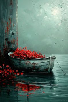 a boat filled with red flowers floating on top of water