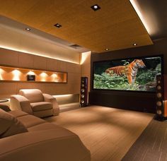 a home theater with couches and a projector screen