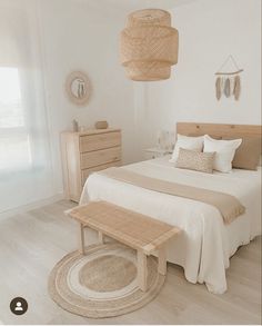 a bedroom with white walls and wooden furniture, including a bed that has a wicker headboard