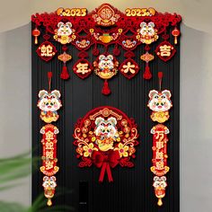 a black door decorated with red and gold decorations