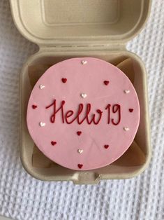 a cake in a box with the word hello on it