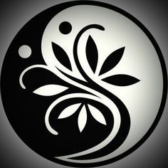 a black and white yin - yang symbol with leaves