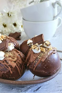 chocolate covered desserts with marshmallows and other toppings on a plate