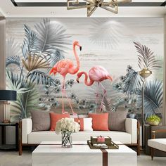 two pink flamingos standing in front of a tropical wall mural