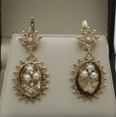 "A pair of vintage Victorian Revival forget me not flower earrings modeled in 14K gold with pearl accents.  We've always adored the symbolism of these flowers - a promise of love and remembrance.  The back of the earrings are stamped \"14K\" for gold purity. Metal: 14K Yellow Gold  Weight: 9.4 grams Measurements: 1.5 inches long by 0.8 inches wide Pearl: 4.4 mm diameter Markings: \"14K\" Condition: In very good vintage condition with some minor surface wear consistent with age.   Follow us on In Victorian Yellow Gold Pearl Earrings For Gift, Victorian Style Yellow Gold Pearl Earrings For Gift, Vintage Yellow Gold Drop Pearl Earrings, Victorian Pearl Earrings For Anniversary, Wedding Flower Earrings In 14k Yellow Gold, Elegant 14k Flower Shaped Jewelry, Elegant 14k Stamped Earrings For Wedding, Elegant 14k Stamped Wedding Earrings, Vintage Flower Shape Wedding Jewelry