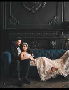 a bride and groom sitting on a blue couch