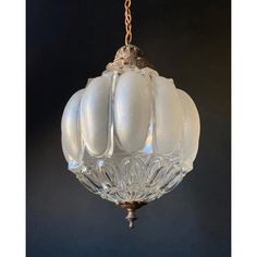 a glass chandelier hanging from a chain