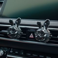 an automatic gear sticker with two bunny ears on it's center console in a car