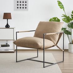 a chair sitting on top of a hard wood floor next to a potted plant