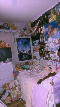 a bed room with a neatly made bed and lots of stuffed animals on the wall