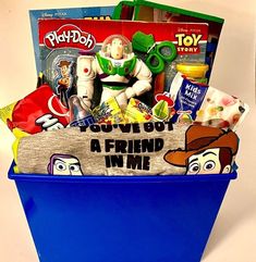 a blue bucket filled with toys and other items