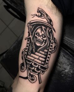 a man's arm with a tattoo on it and a skull in the middle