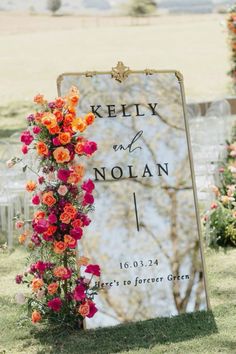 a sign that has flowers on it and the words kelly and nolan written in black