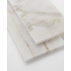 two pieces of white marble sitting on top of each other