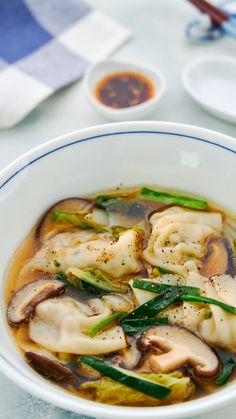 a white bowl filled with food on top of a table