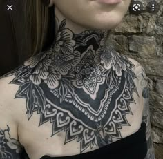 a woman with tattoos on her neck and chest