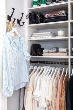 an organized closet with clothes and handbags