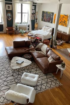 a living room filled with lots of furniture on top of a hard wood floored floor