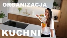 a woman standing in front of a kitchen counter