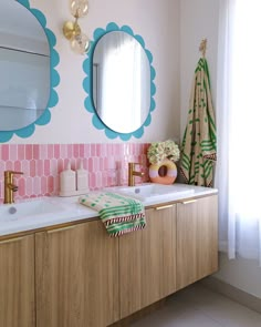 a bathroom with pink and blue tiles on the wall