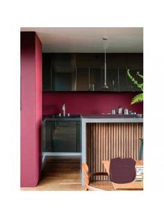 a kitchen with wooden floors and purple walls