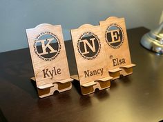 three wooden name tags sitting on top of a table