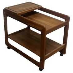 a wooden serving cart with two trays on it's sides and one holding a cutting board