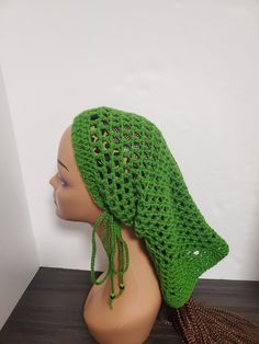 Forest Green Crochet Dreadlock Sleeve Tube Hat Add a touch of reggae to your style with this beautiful Forest Green Crochet Dreadlock Sleeve Tube Hat from HaT. Handmade with love, this hat features a mesh pattern and plastic beads accents, perfect for a casual occasion or travel. The drawstring and adjustable feature make it suitable for all head sizes, while the acrylic material and yarn fabric type ensure comfort and durability. Embrace the rastafarian theme with this stylish hat, suitable for Cheap Green Crochet Yarn Hat, Bohemian Beanie Headwrap, Adjustable Casual Bonnet, Adjustable Bohemian Winter Headwrap, Casual Adjustable Winter Headwrap, Casual Adjustable Headwrap For Winter, Casual One-size Beach Bonnet, Bohemian Crochet Hat For Outdoor, One Size, Casual Beach Bonnet One Size