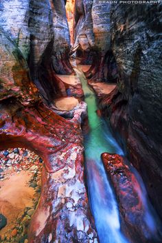 the water is running through the narrow canyons in the mountains, and it looks like they are painted with colors