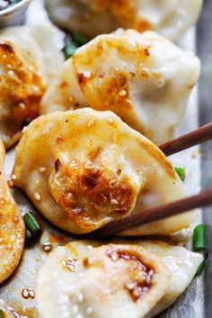 some dumplings with chopsticks in them on a tray