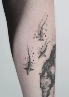 a man's arm with birds flying around it