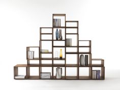 a book shelf filled with lots of books and vases on top of each other