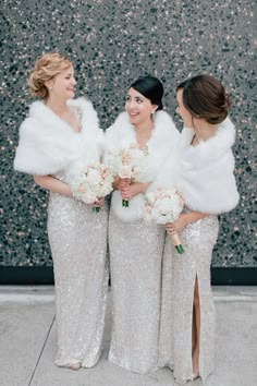 three bridesmaids in sequin dresses and fur stoles