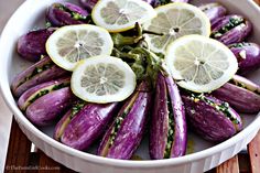 there are lemons and other vegetables in the bowl on the table, ready to be eaten