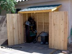 a wooden shed with a vacuum inside it