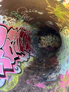 a tunnel with graffiti all over it