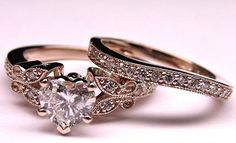 two wedding rings with a heart shaped diamond