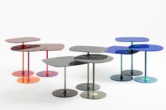 three tables with different colored tops on each side and one has an upside down glass top