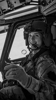 a black and white photo of a woman in a helicopter cockpit