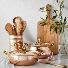 copper pots and pans with wooden utensils