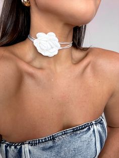 a woman wearing a white flower necklace